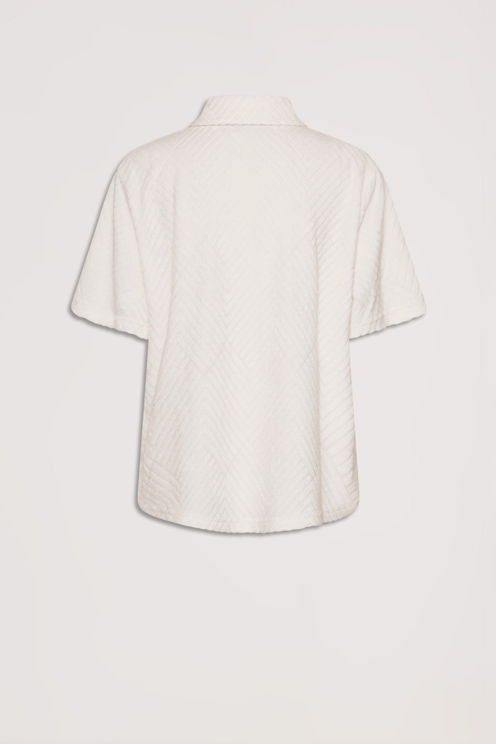 Back view of a short-sleeve terry shirt in a soft vanilla shade with subtle textured patterning.