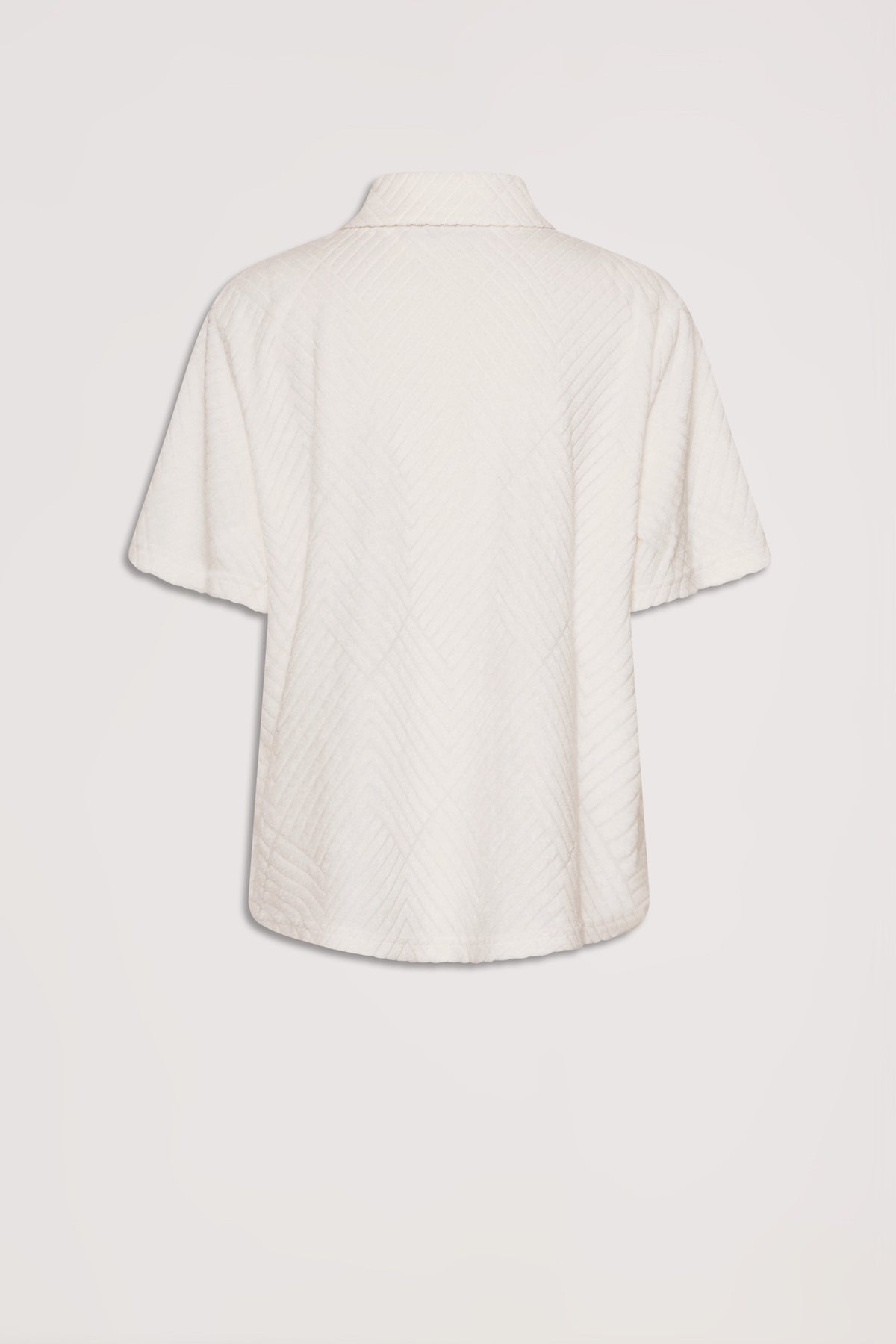 Back view of a short-sleeve terry shirt in a soft vanilla shade with subtle textured patterning.