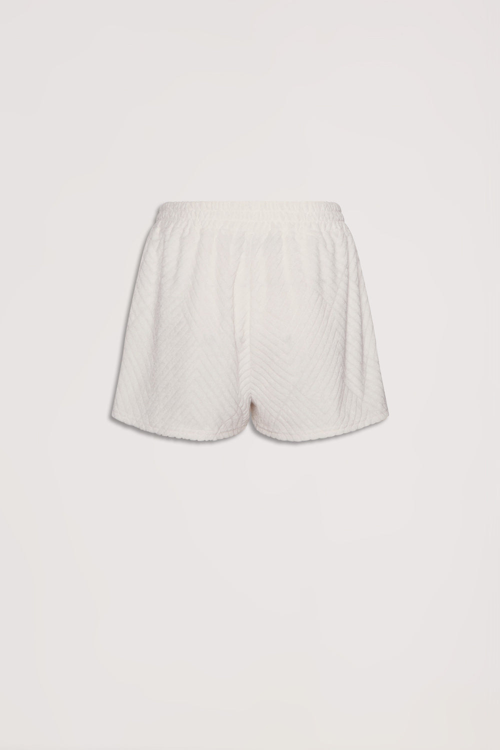 Soft textured cream terry shorts with elastic waistband, offering a relaxed and comfortable fit for everyday wear