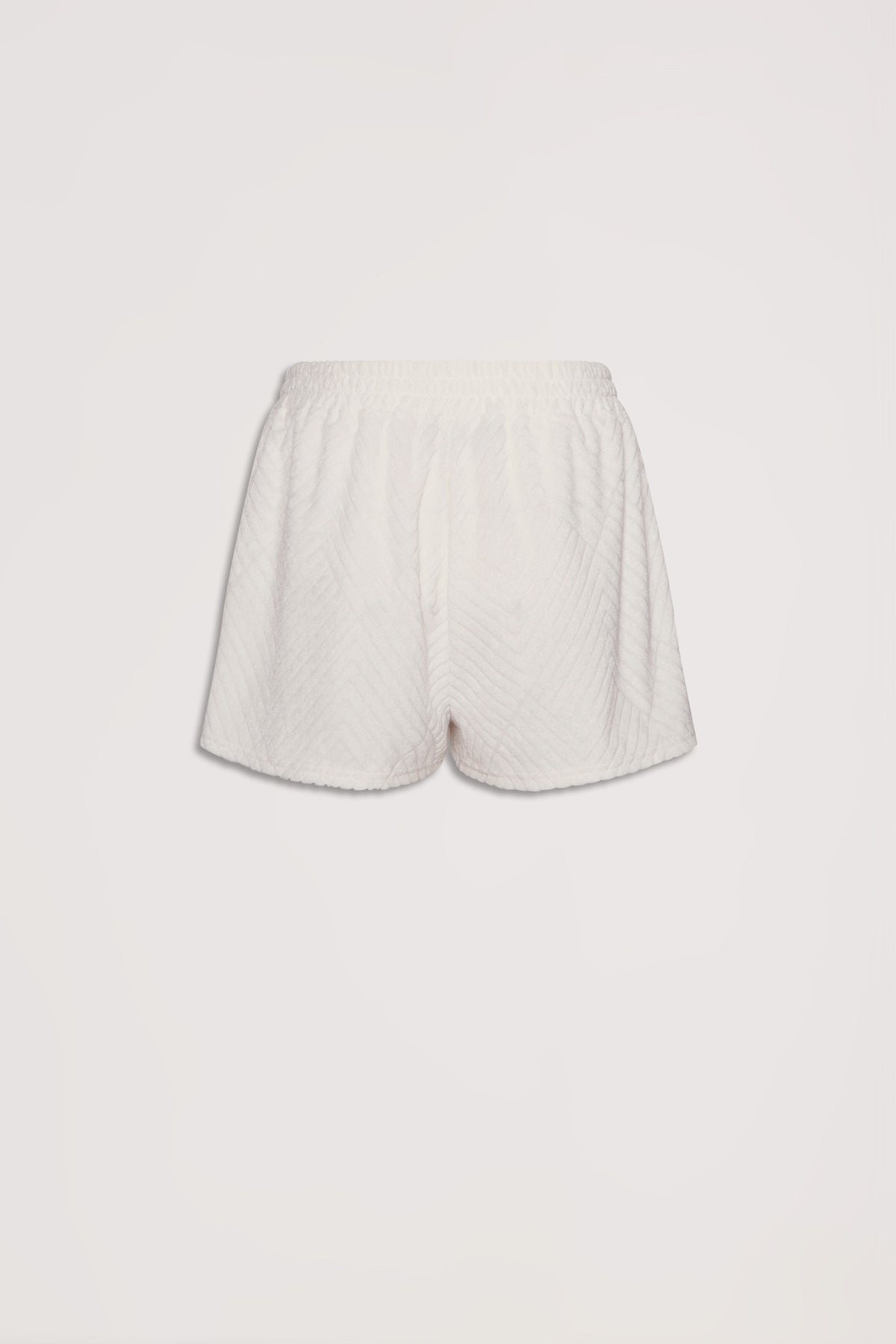 Soft textured cream terry shorts with elastic waistband, offering a relaxed and comfortable fit for everyday wear