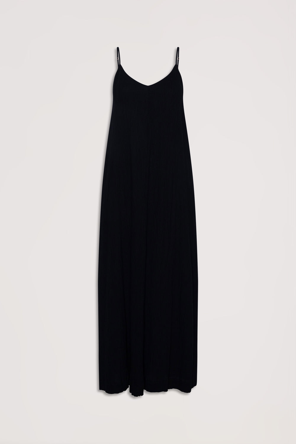 Flowy black maxi dress with thin adjustable straps and a subtle v-neckline for effortless elegance.