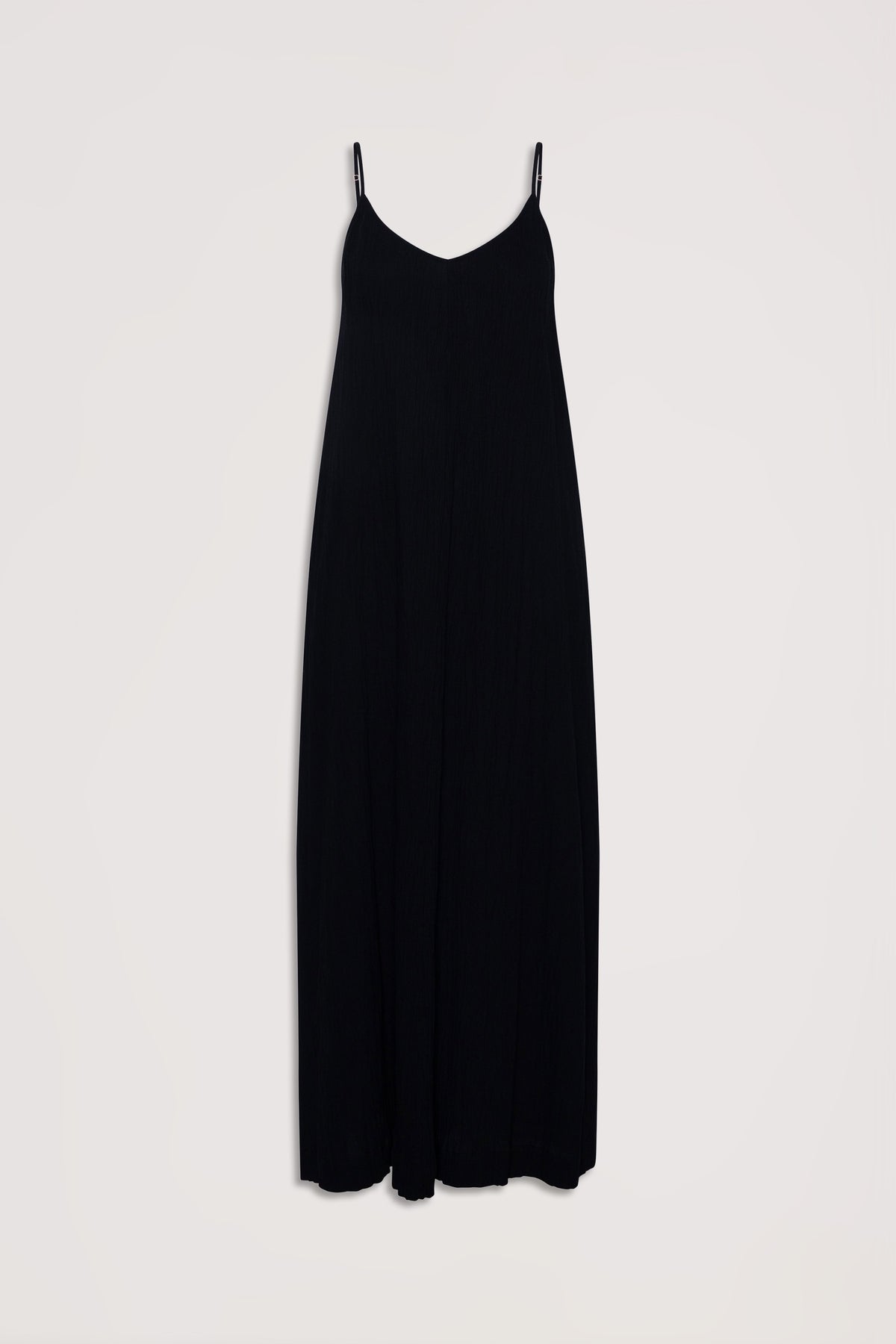 Flowy black maxi dress with thin adjustable straps and a subtle v-neckline for effortless elegance.