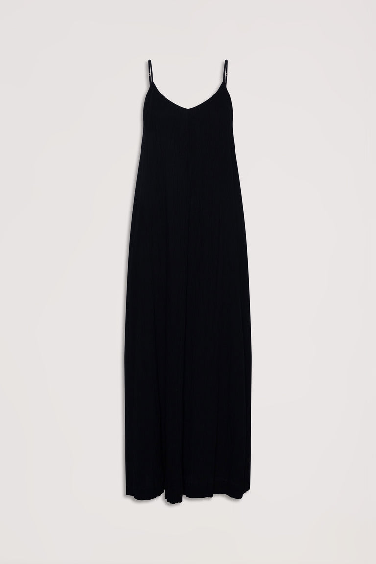 Flowy black maxi dress with thin adjustable straps and a subtle v-neckline for effortless elegance.
