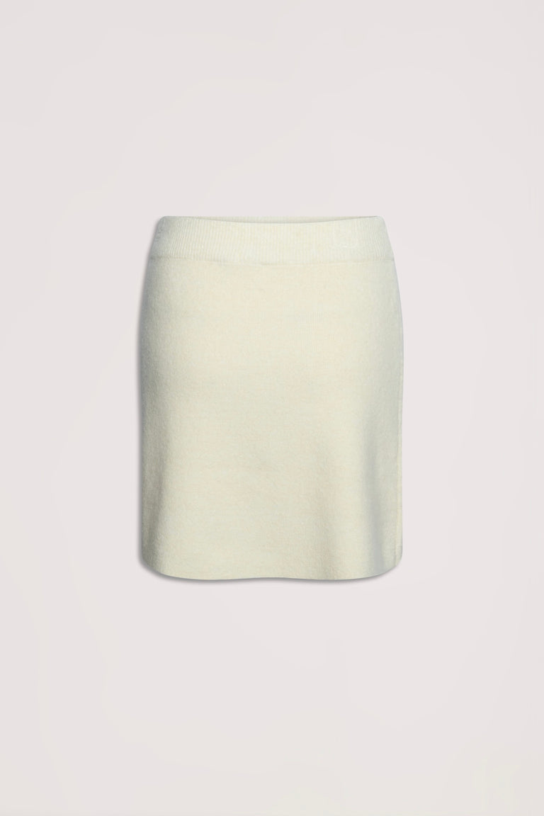 Cream-colored knit mini skirt with a soft texture and elastic waistband for comfortable everyday wear