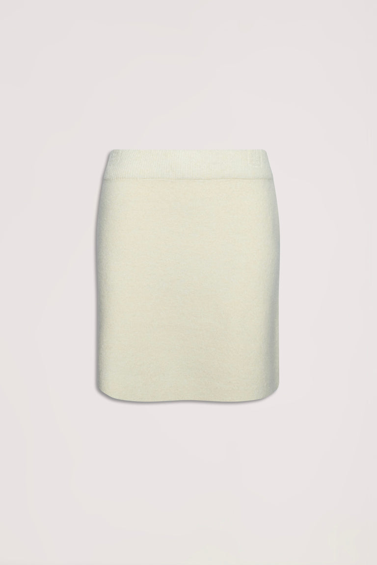 Cream-colored knit mini skirt with a streamlined silhouette, ideal for versatile everyday wear.