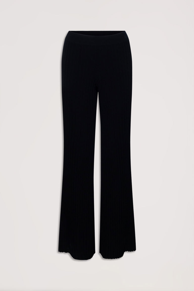Black ribbed knit pants with a flared silhouette and elastic waistband, laid flat against a neutral background