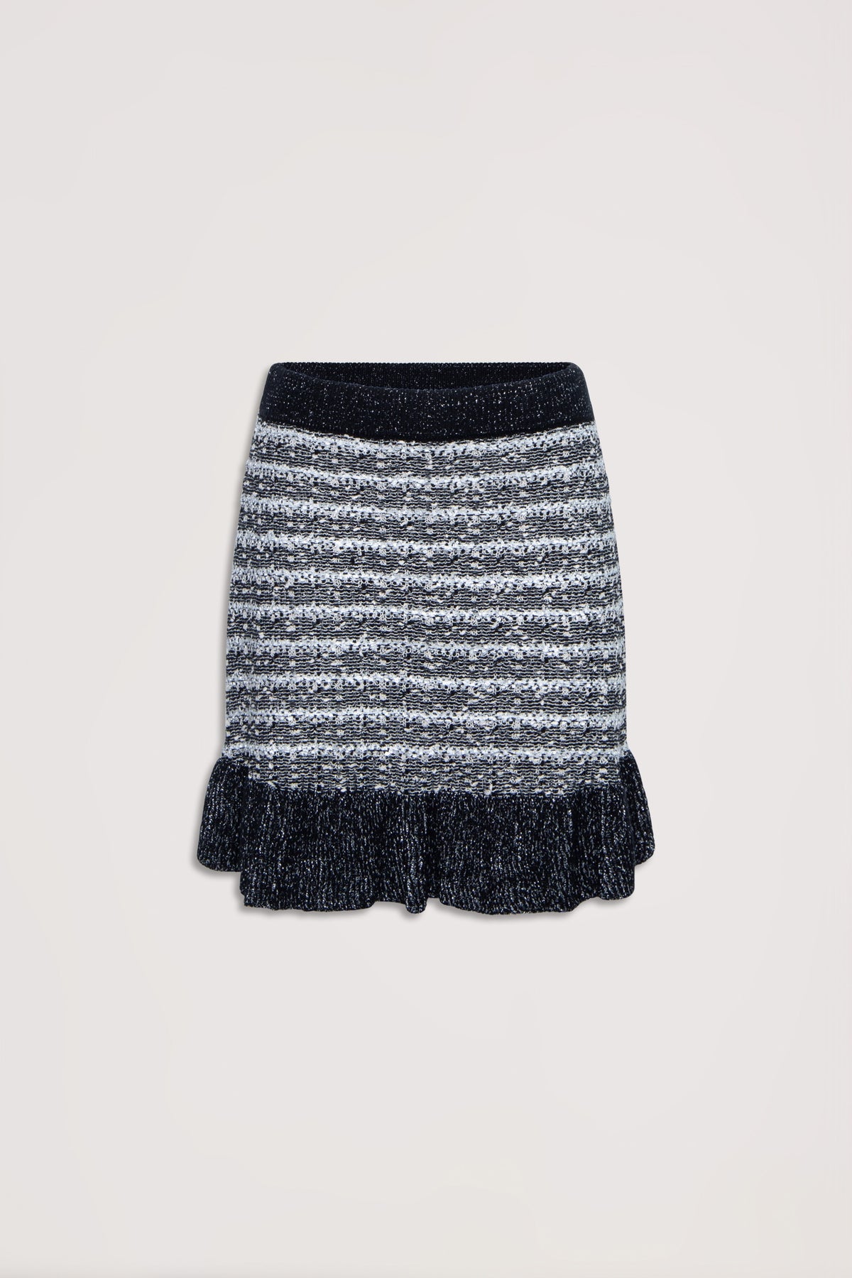 Black and white striped knit skirt with ruffled hem and a cozy textured waistband, flat lay on neutral background