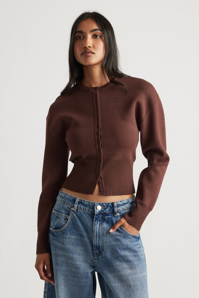 Slim-fit rich mocha cardigan with button front and cinched waist paired with relaxed blue denim jeans
