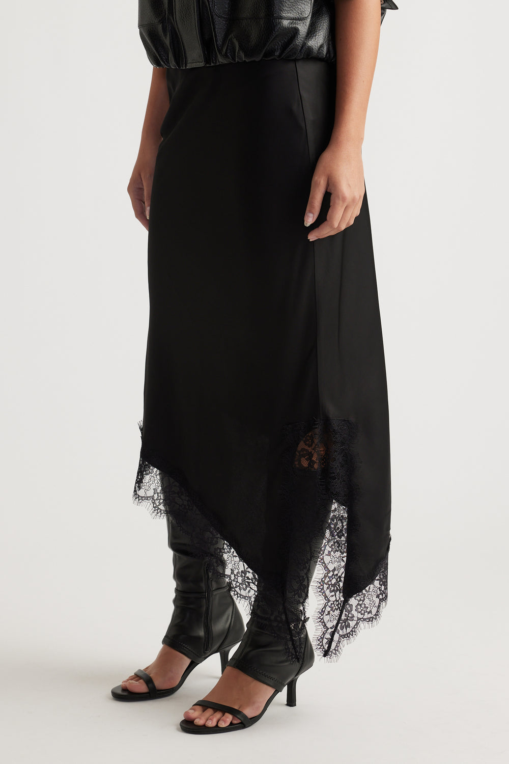 Karla Lace Slip Skirt in black with delicate lace hem styled with black strappy heels by DECJUBA Australian fashion brand