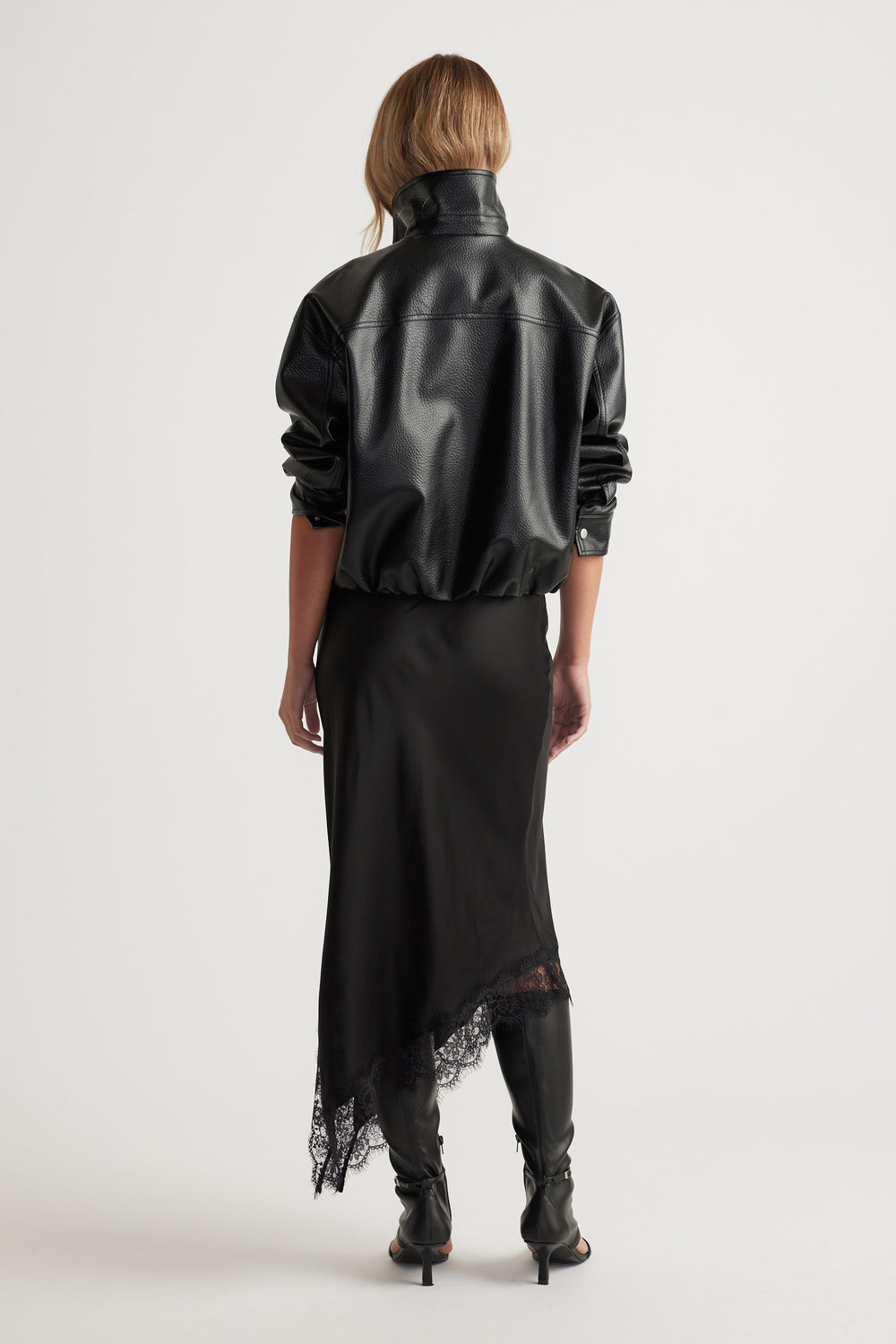 Karla Lace Slip Skirt in black satin with lace trim and asymmetric hem paired with leather jacket and boots by DECJUBA Australian brand
