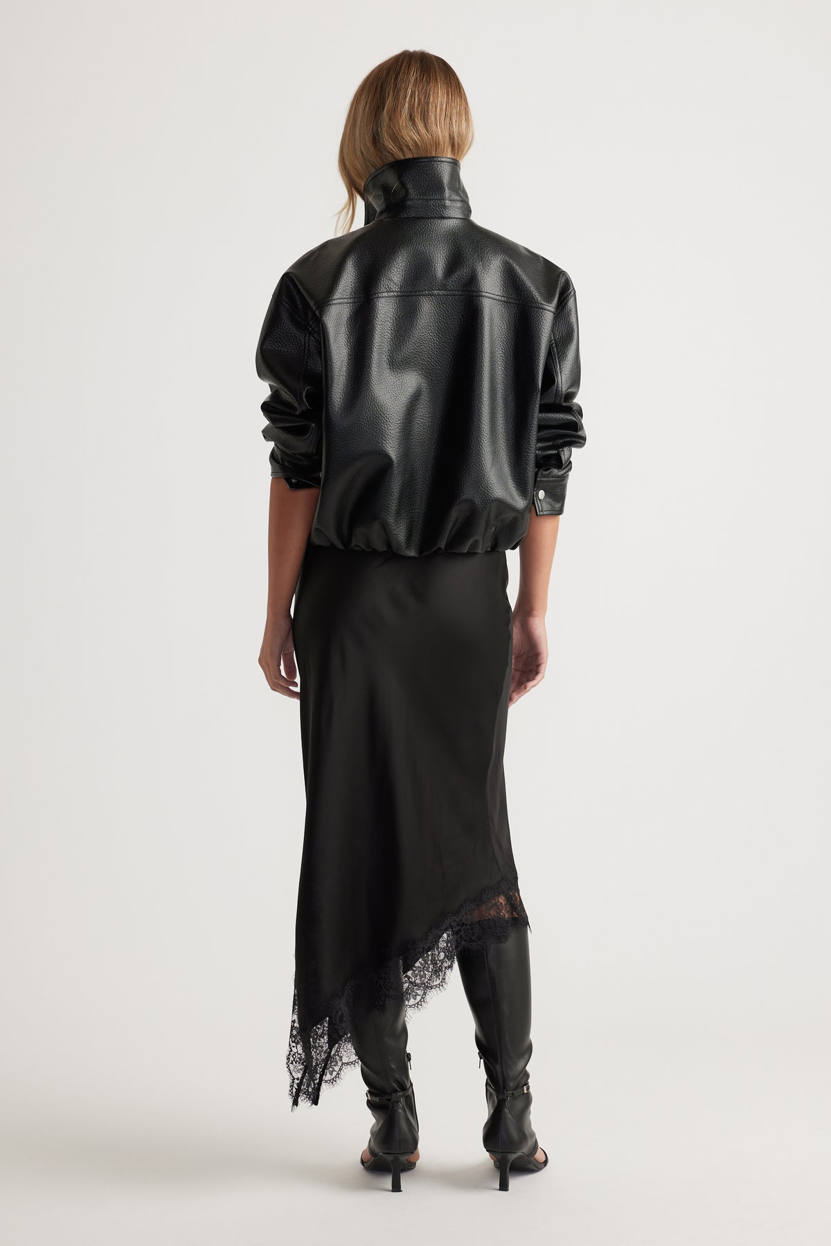 Karla Lace Slip Skirt in black satin with lace trim and asymmetric hem paired with leather jacket and boots by DECJUBA Australian brand
