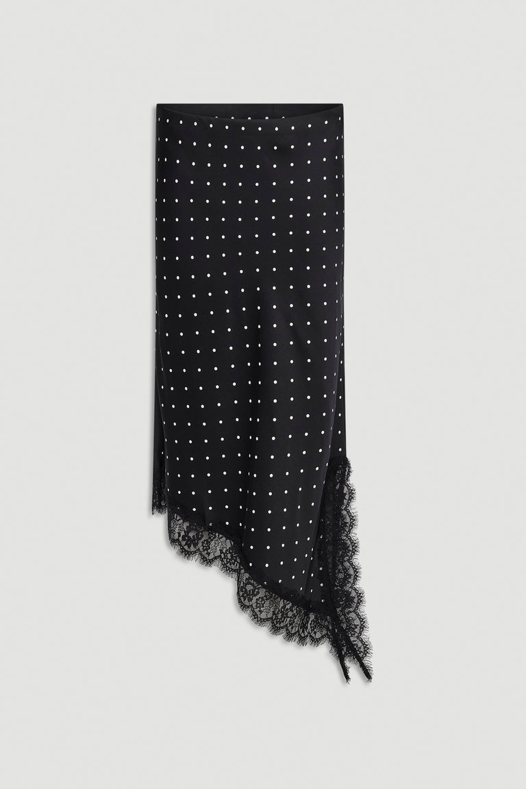 Black midi skirt with white polka dots, asymmetric lace-trimmed hem, and side slit detail against white background
