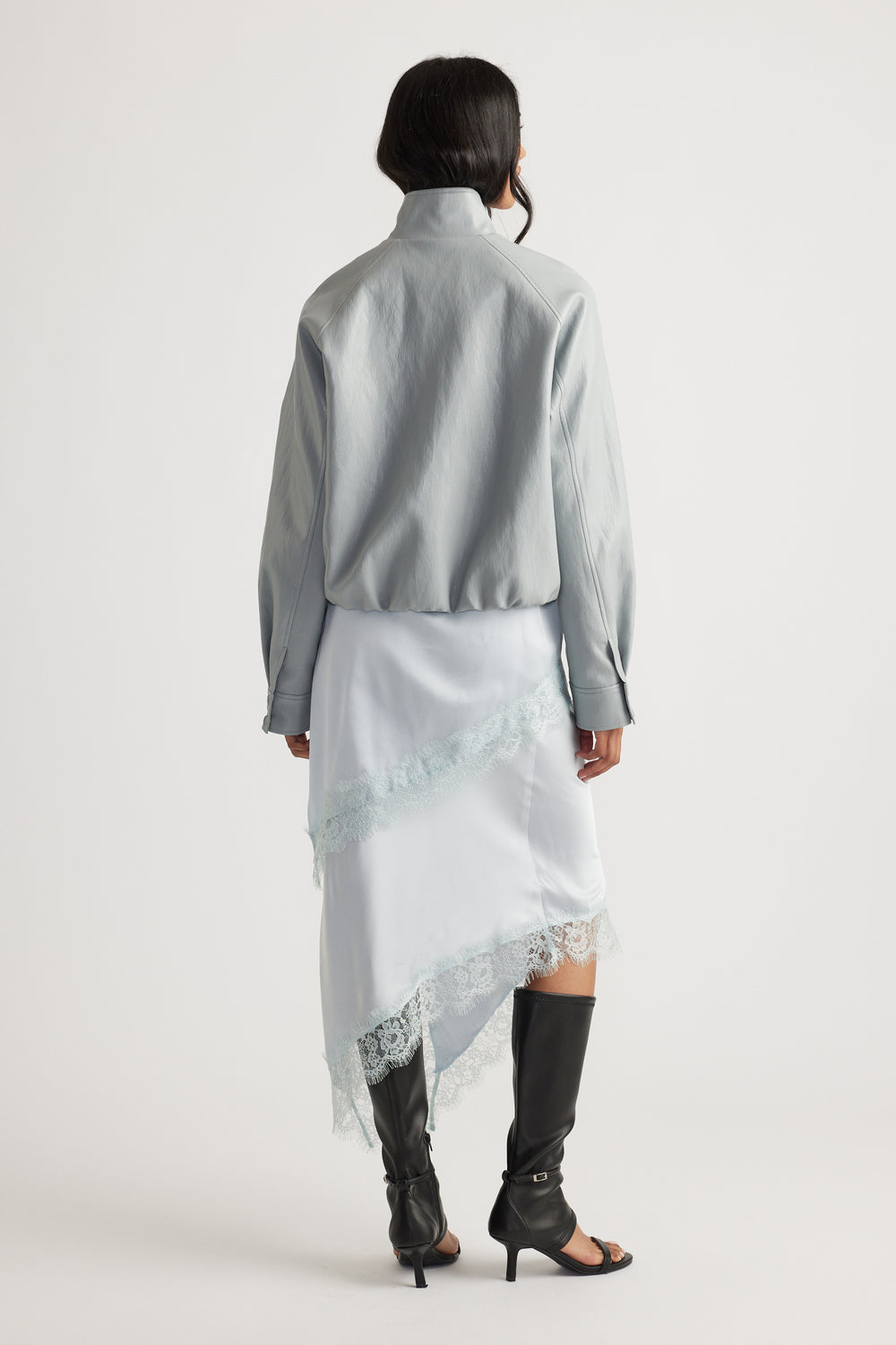 Back view of woman wearing Karla Lace Slip Skirt in 100% viscose with nylon lace trim, styled by DECJUBA Australian fashion brand