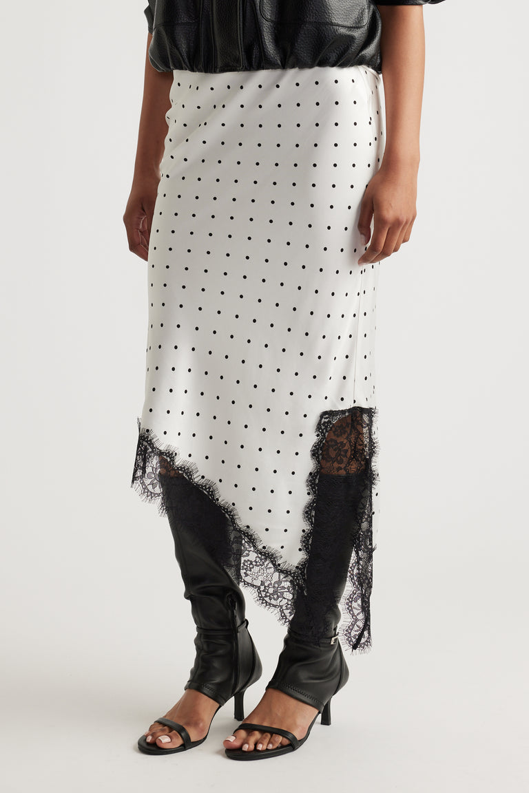 Karla Lace Slip Skirt in ivory with black polka dots, featuring delicate black lace trim and an asymmetrical hem