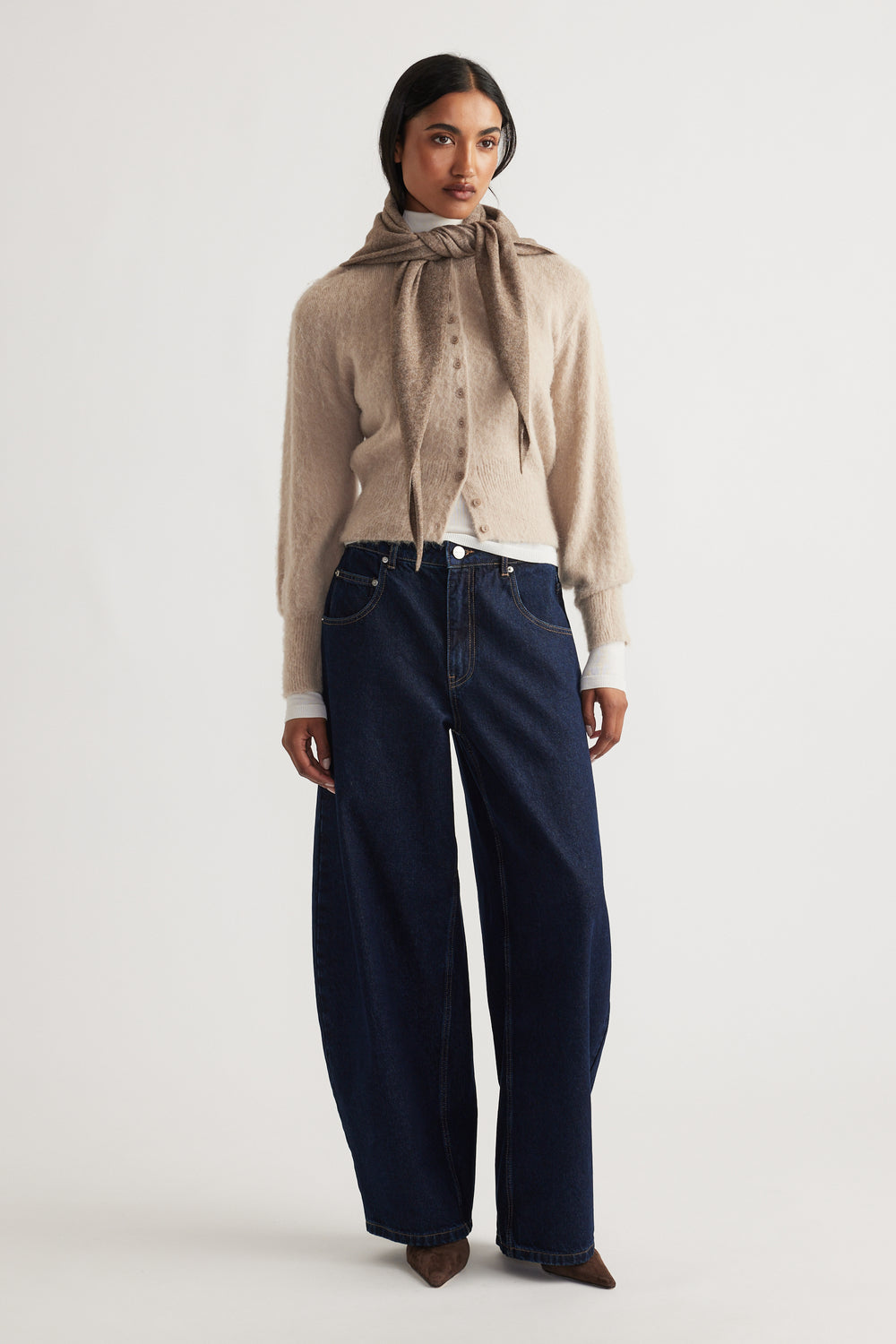 Heather Triangle Scarf in soft cocoa tone styled over a cozy beige cardigan with wide-leg dark denim jeans by DECJUBA