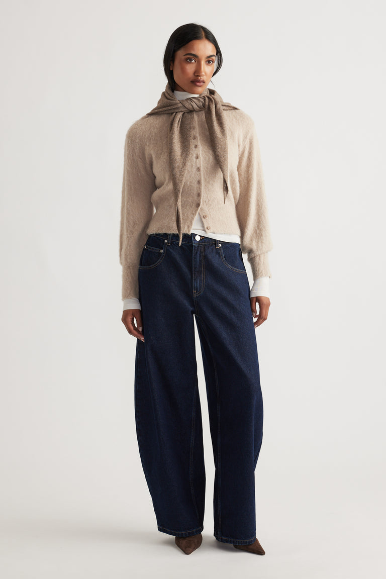 Heather Triangle Scarf in soft cocoa tone styled over a cozy beige cardigan with wide-leg dark denim jeans by DECJUBA