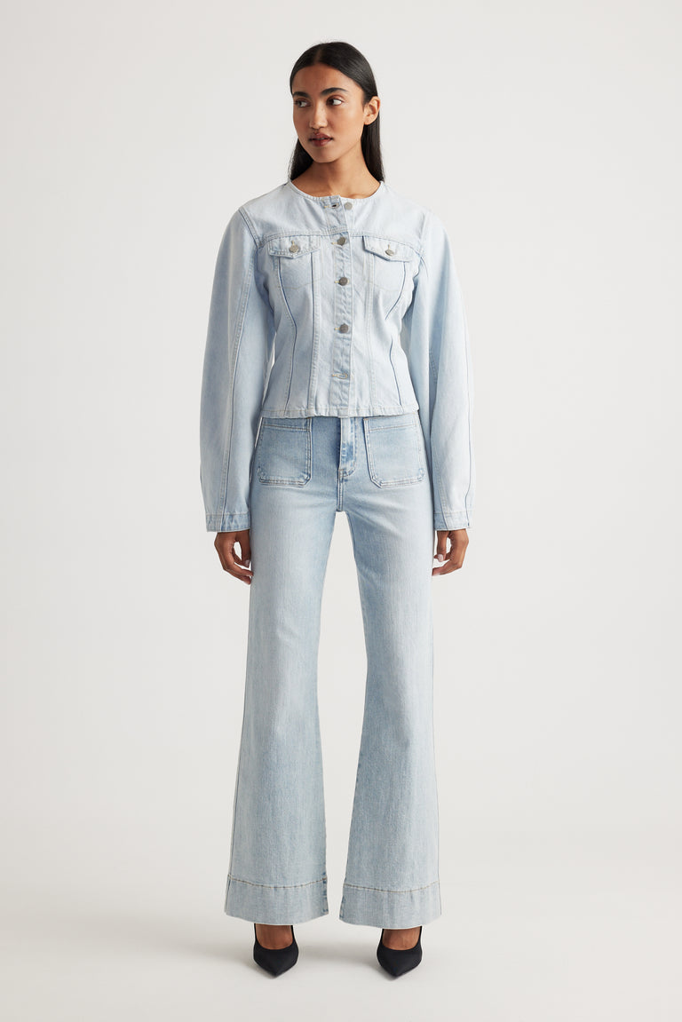Woman wearing light wash Tori Flare Jean with wide hem and front pockets styled by Decjuba Australian fashion brand