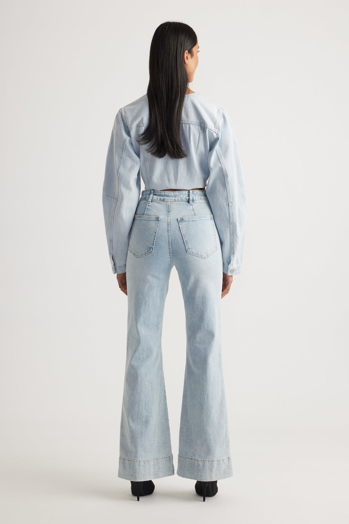 Rear view of Tori Flare Jean in light denim with wide cuffs styled by Decjuba Australian fashion brand