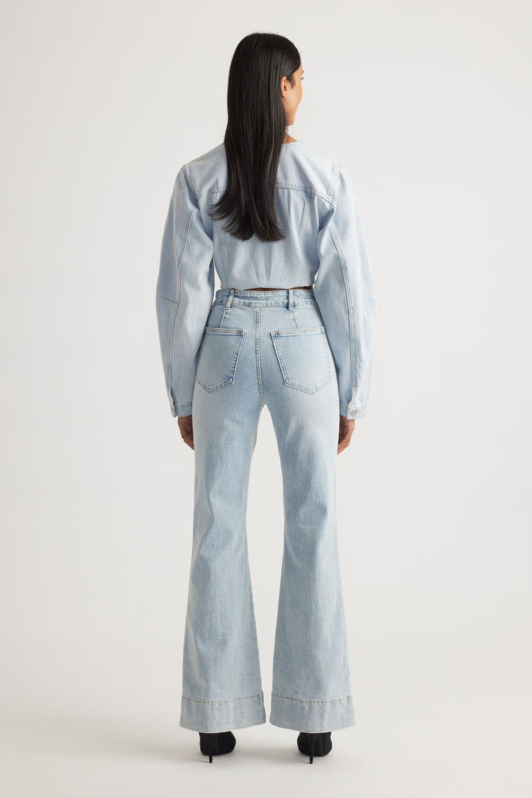 Rear view of Tori Flare Jean in light denim with wide cuffs styled by Decjuba Australian fashion brand