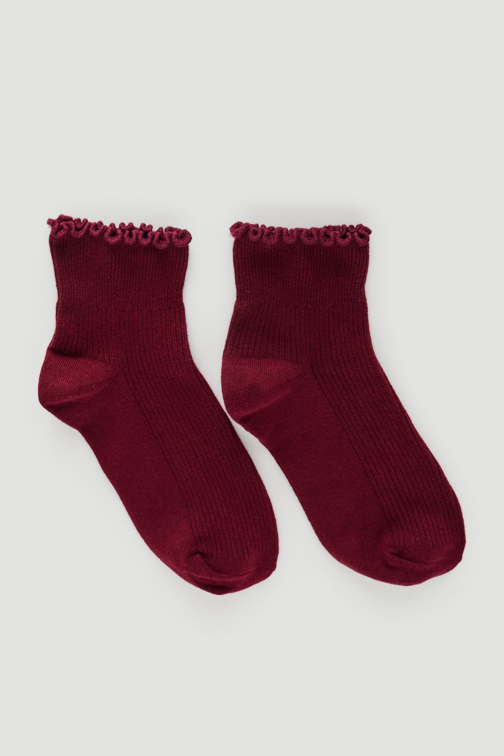Pair of deep plum ribbed socks with delicate frill trim at the ankle, ideal for everyday comfortable wear