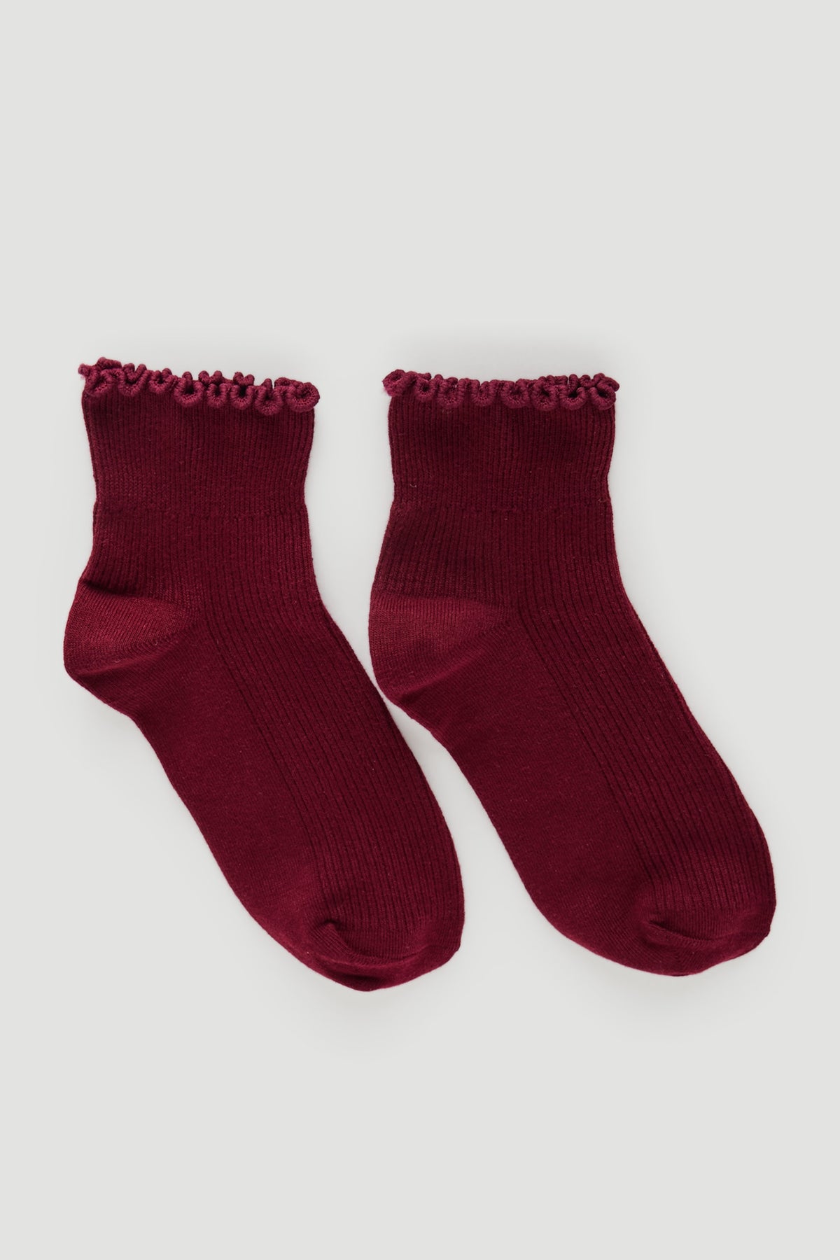 Pair of deep plum ribbed socks with delicate frill trim at the ankle, ideal for everyday comfortable wear
