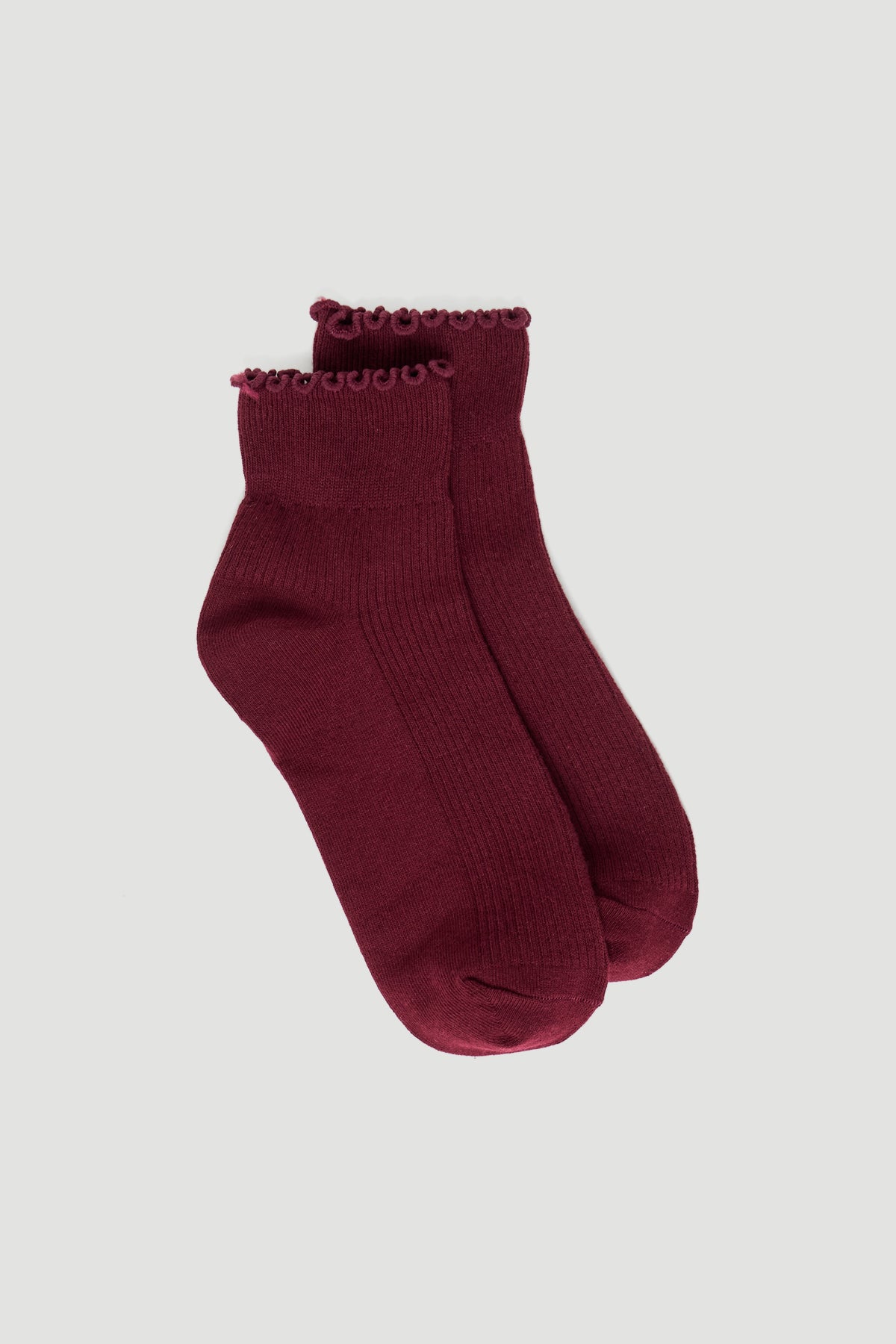 Pair of plum-colored ankle socks with delicate frilled edges and ribbed detailing for a stylish touch