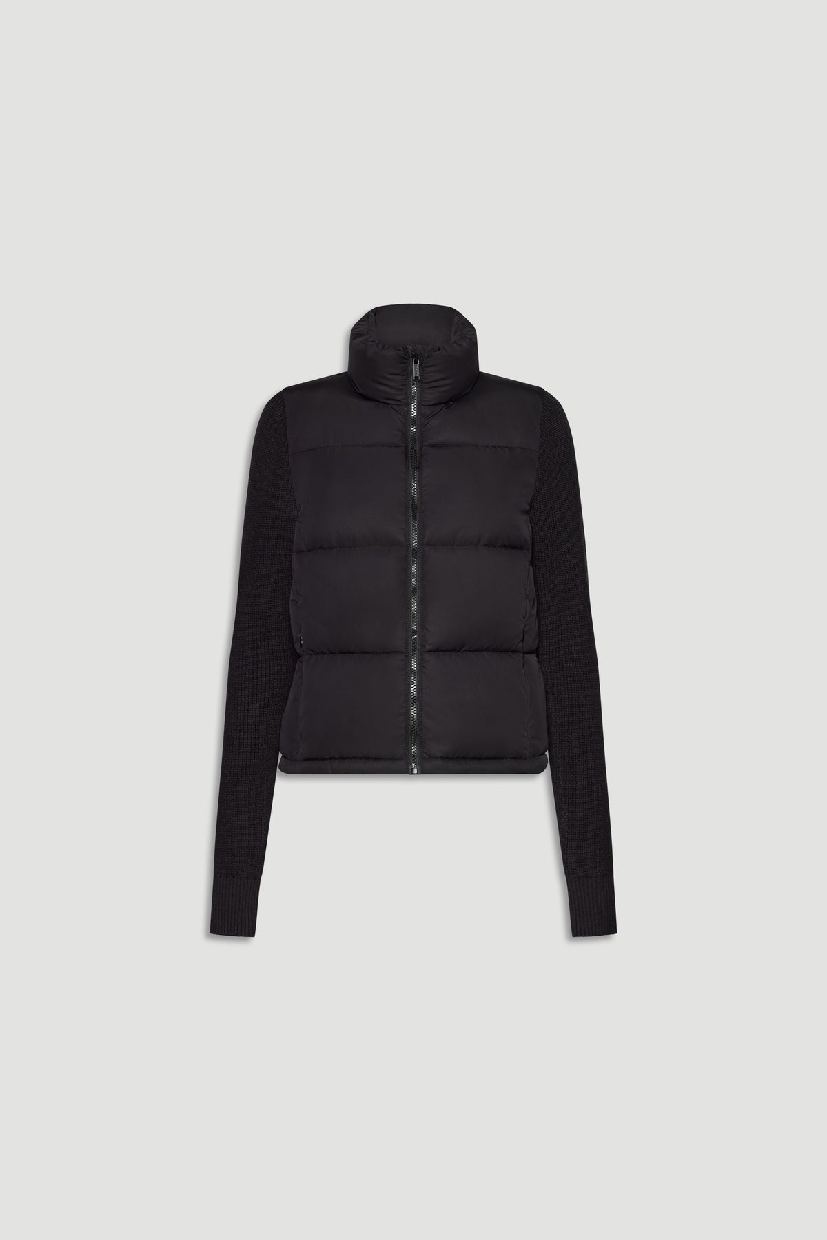 Black knit puffer jacket with padded front and ribbed long sleeves, featuring a high collar and front zip closure.