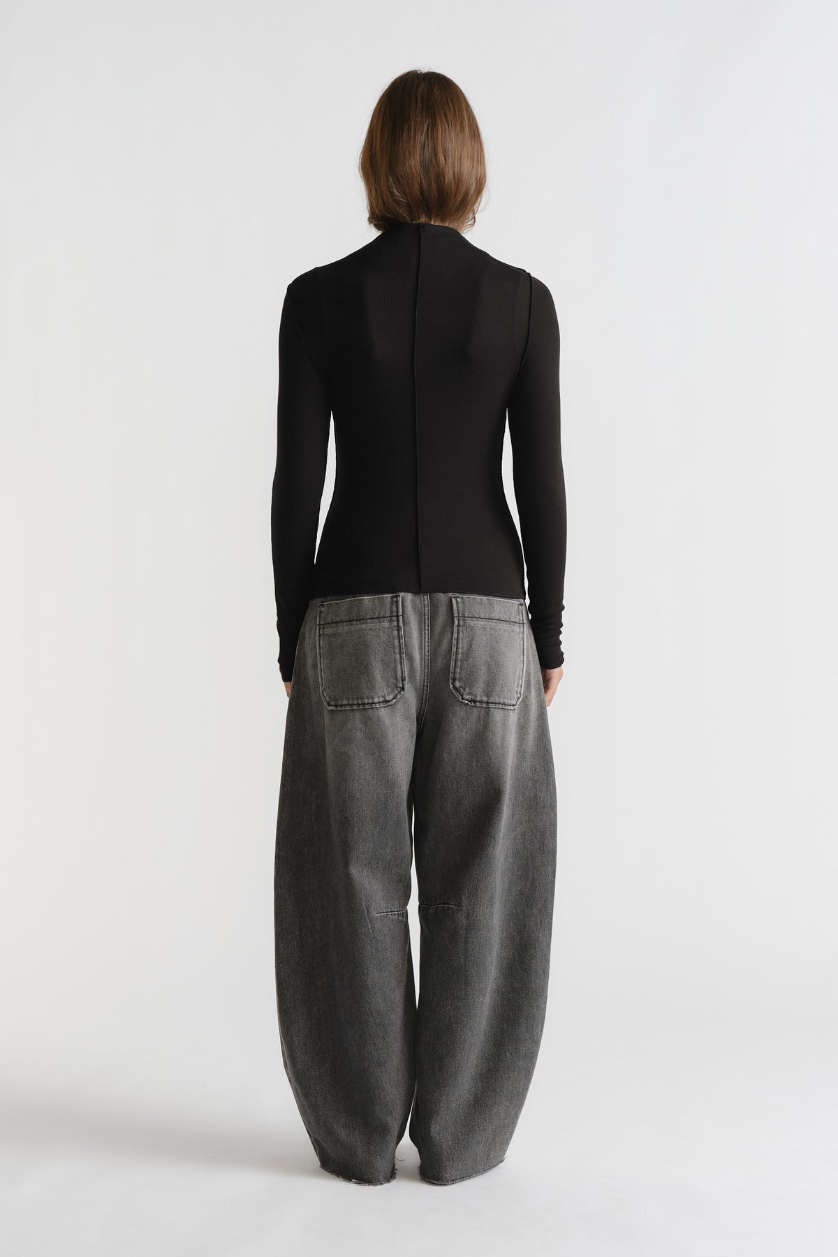D-Luxe Semi Sheer Long Sleeve in black with fitted design styled with relaxed grey wide-leg denim by DECJUBA Australian brand