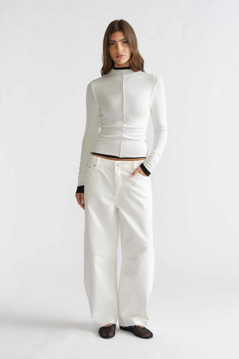 D-Luxe Semi Sheer Long Sleeve in sleek white with contrasting black trim, paired with wide-leg white jeans by DECJUBA Australian fashion brand