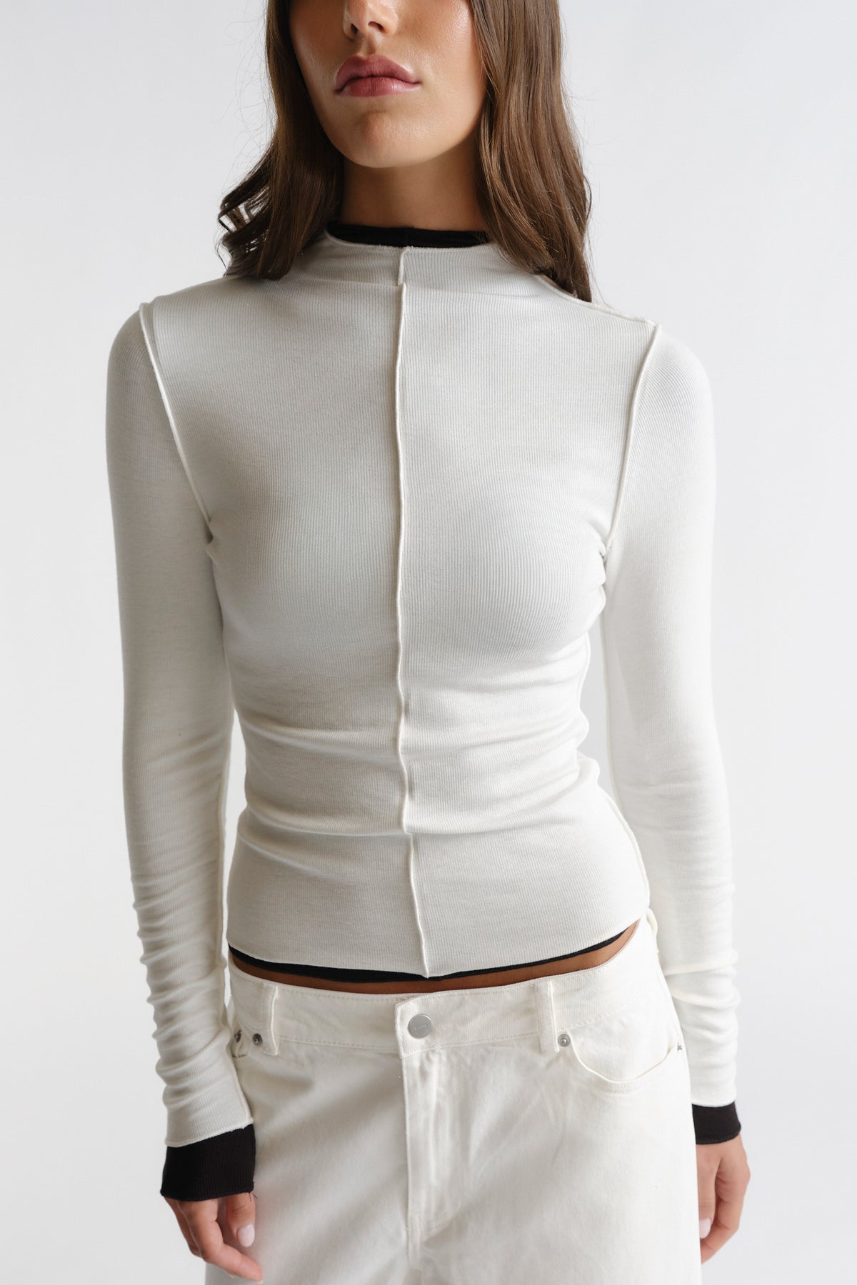 D-Luxe Semi Sheer Long Sleeve in soft white with subtle seam detailing and black cuff accents by DECJUBA Australian fashion brand