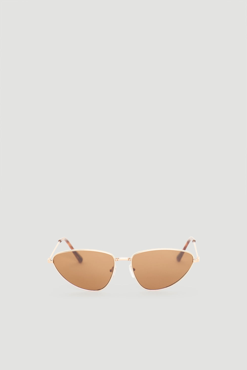 Sleek cat eye sunglasses with warm brown lenses and slender gold-tone frame for a chic, modern accessory.