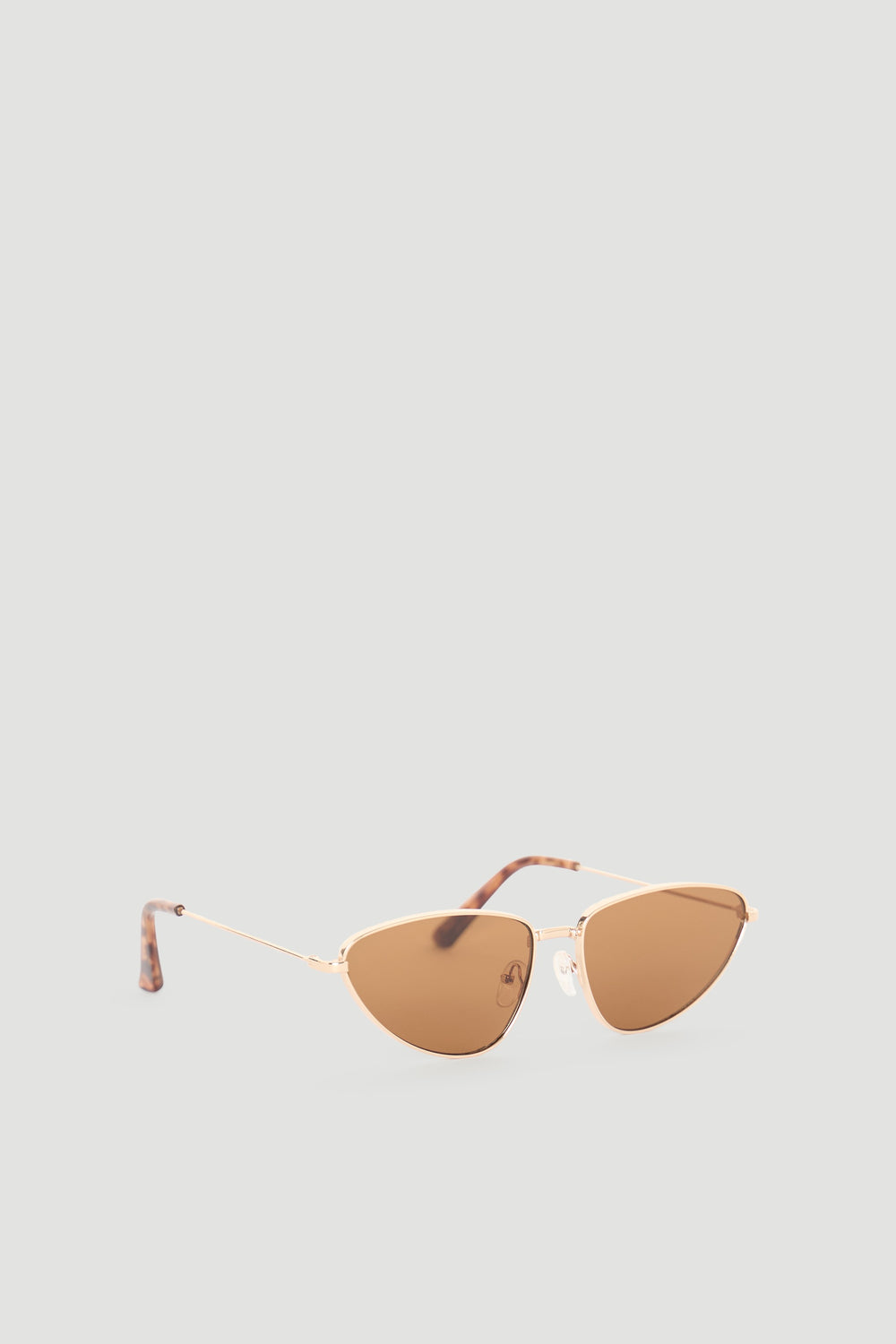 Sleek cat eye sunglasses with warm brown lenses and slim gold-tone frames for a chic, timeless look.