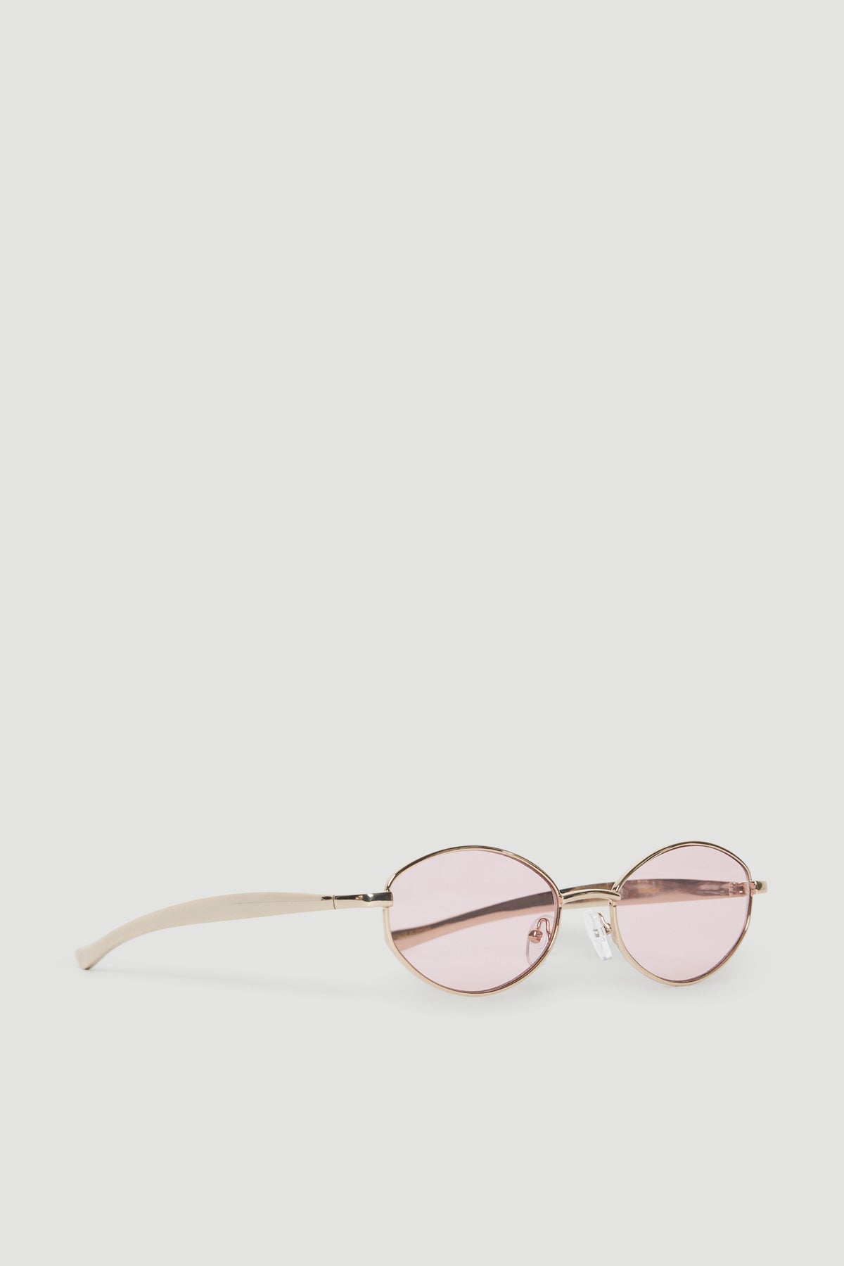 Round gold metal sunglasses with pink tinted lenses and slim arms