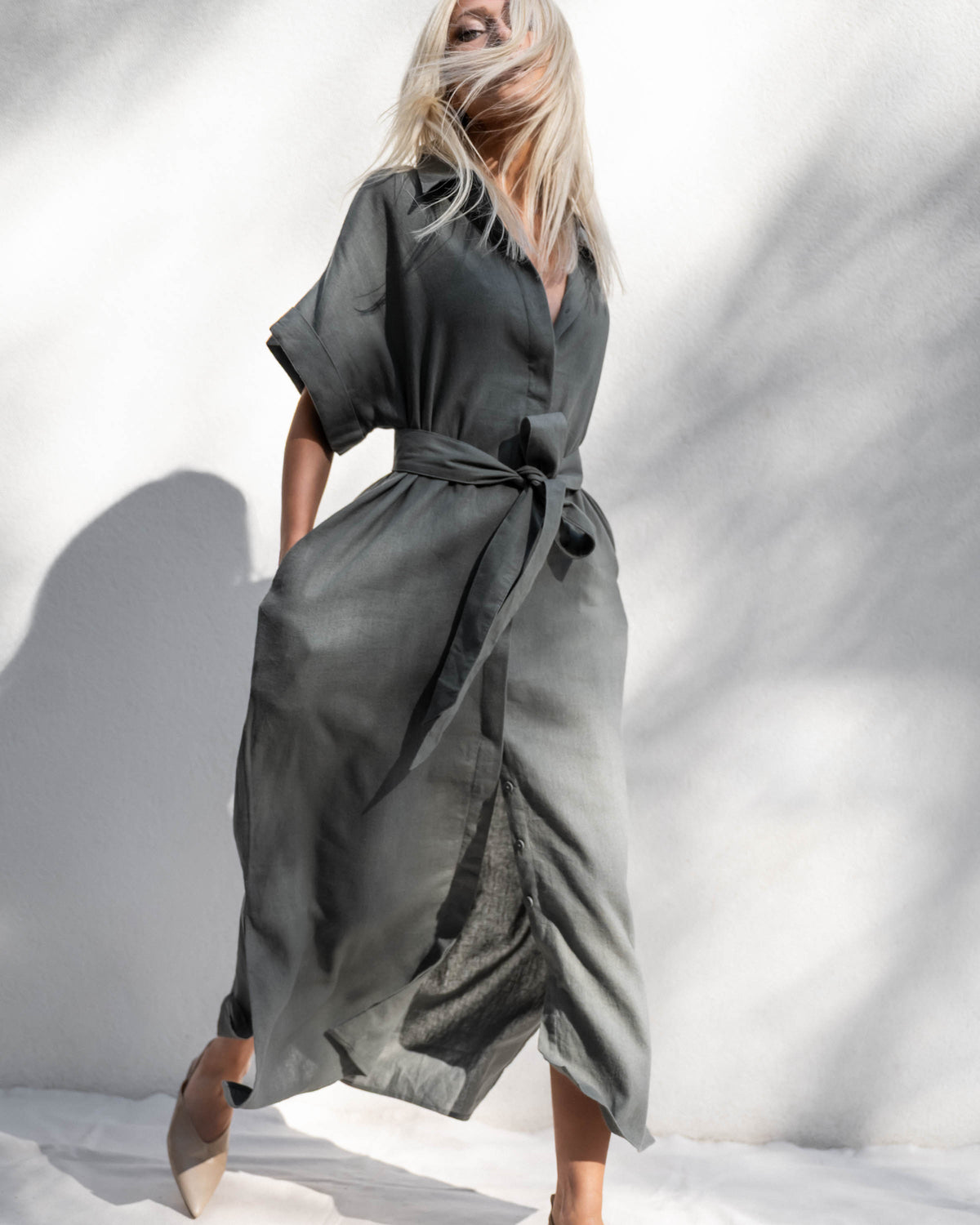 Woman wearing D-Luxe Linen Blend Midi Dress in charcoal gray with tie waist, gallery position 5, portrait orientation, 2400x3000px