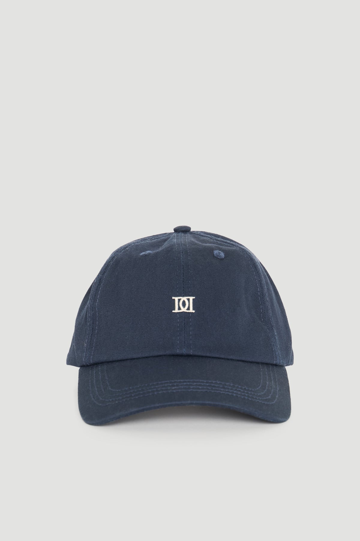 Navy blue casual cap with minimalist embroidered logo, designed for versatile everyday wear and effortless style.