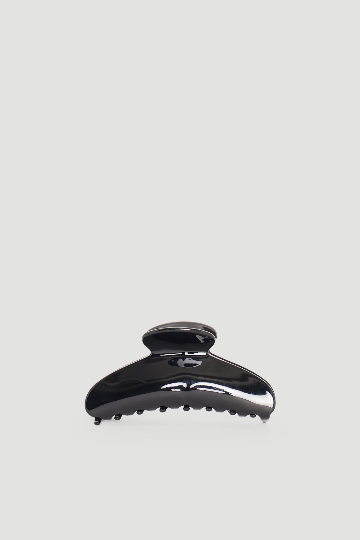 Glossy black hair claw clip with curved design and sturdy teeth for secure hair hold and everyday wear