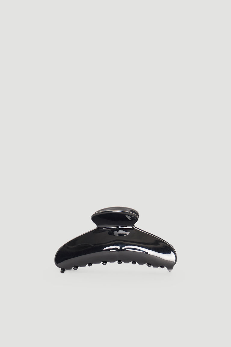 Glossy black hair claw clip with curved design and sturdy teeth for secure hair hold and everyday wear