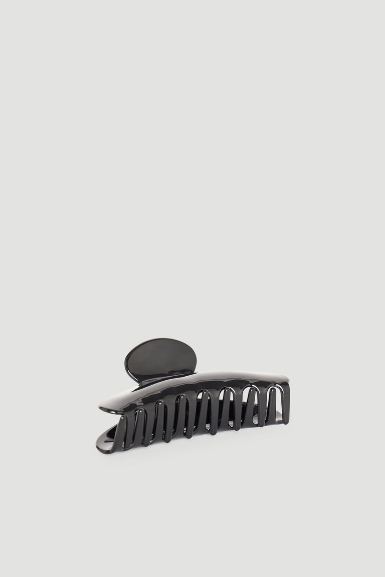 Sleek black hair claw clip with curved design for easy and stylish hair styling and secure hold