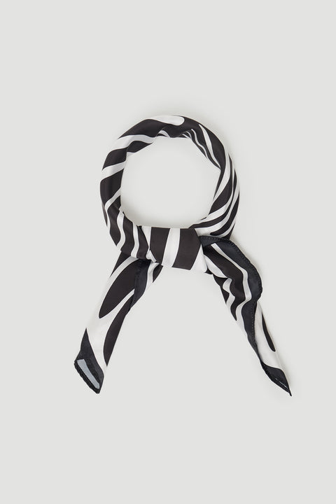 Black and white striped scarf loosely tied in a smooth fabric with a subtle sheen against a light background