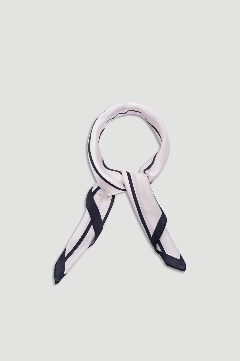 Polly Scarf in soft fabric featuring a pale base with bold black border stripes for a timeless, elegant accessory.