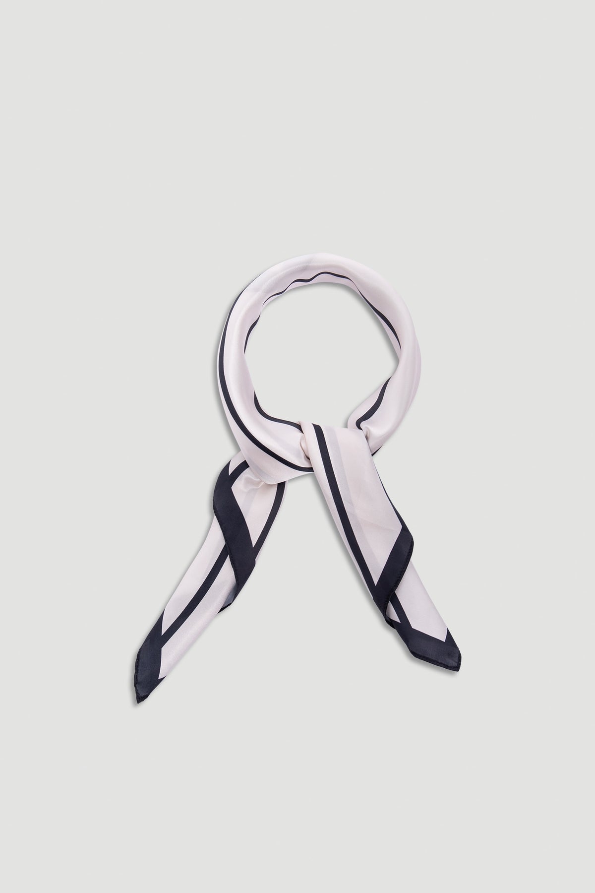Polly Scarf in soft fabric featuring a pale base with bold black border stripes for a timeless, elegant accessory.