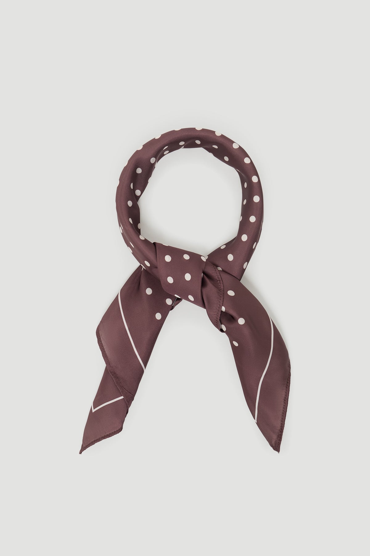 Polly Scarf in portrait view, lightweight smooth fabric with white polka dots and easy fold styling option