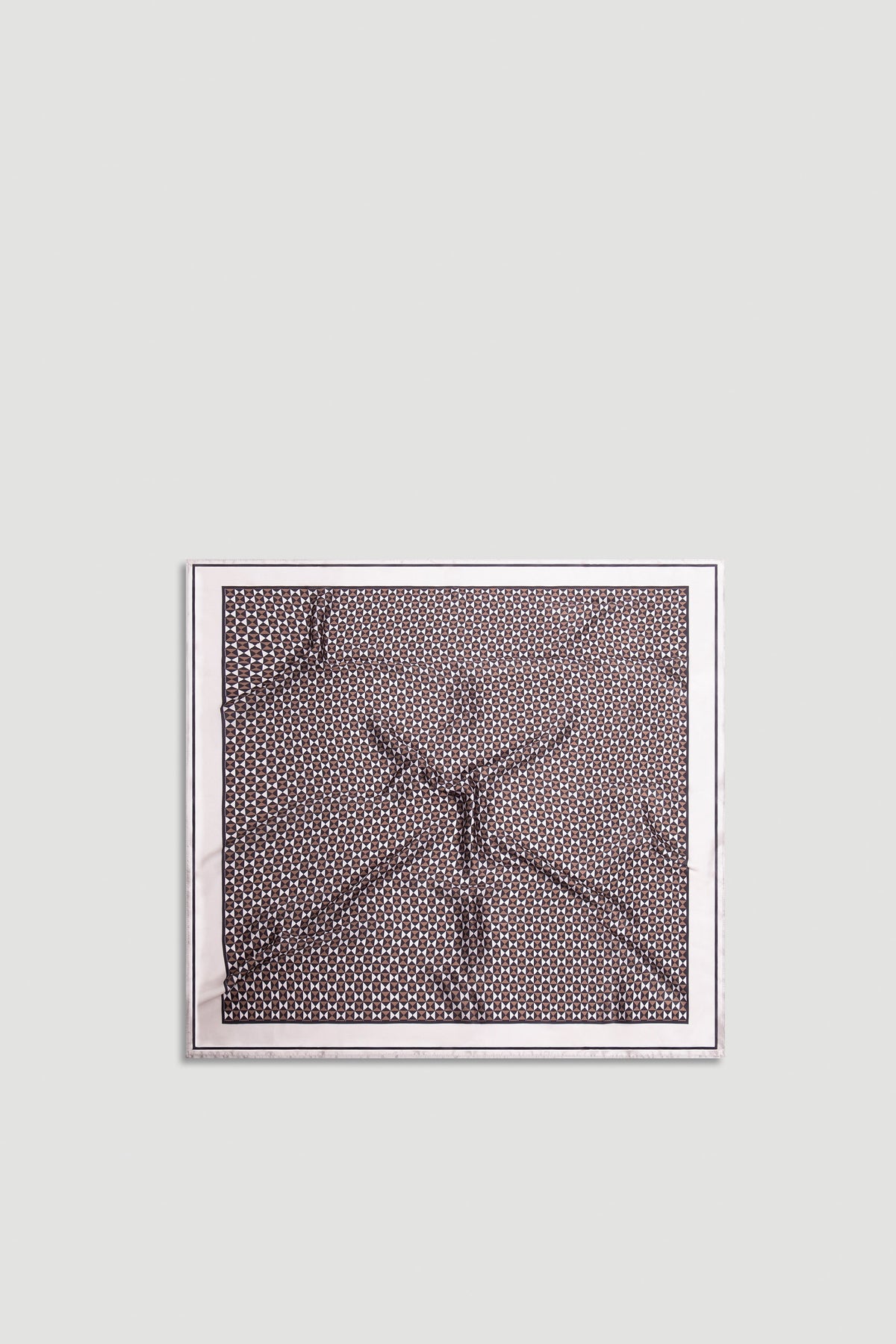 Polly Scarf with intricate geometric pattern in warm neutral tones framed by a soft light border for versatile styling.