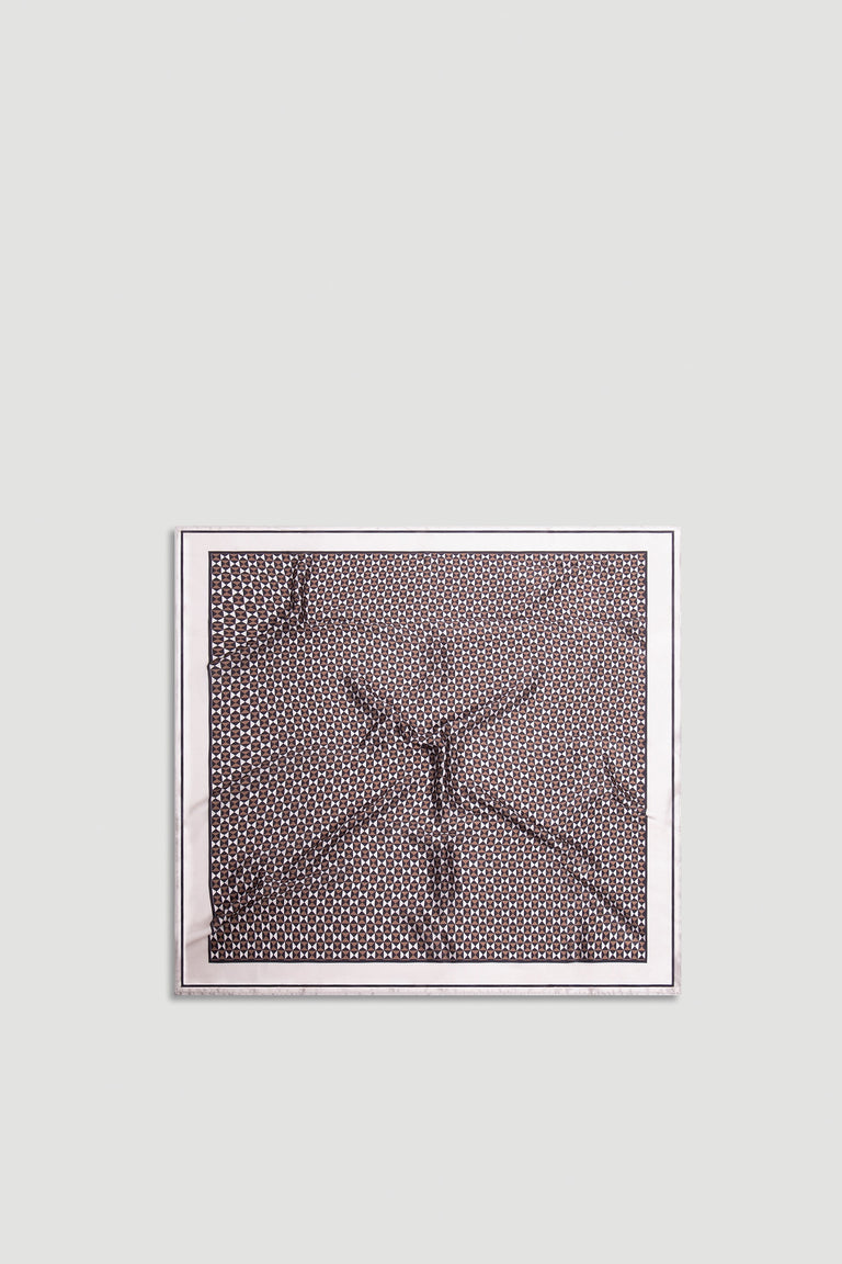 Polly Scarf with intricate geometric pattern in warm neutral tones framed by a soft light border for versatile styling.