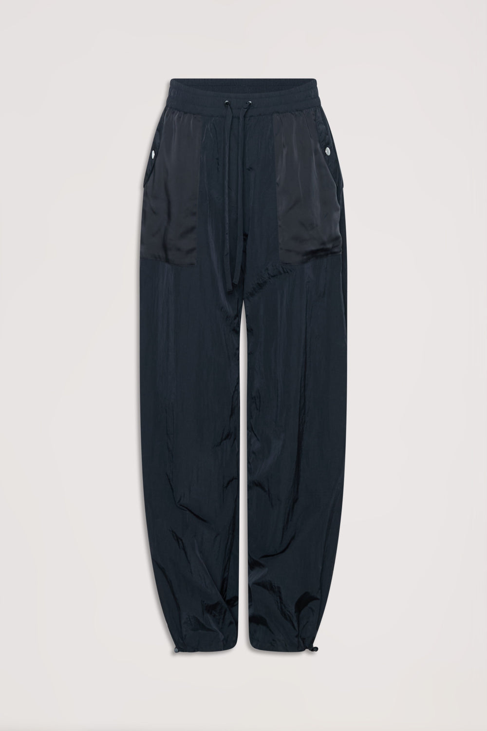 Black relaxed fit parachute-style joggers with drawstring waist and buttoned side pockets.