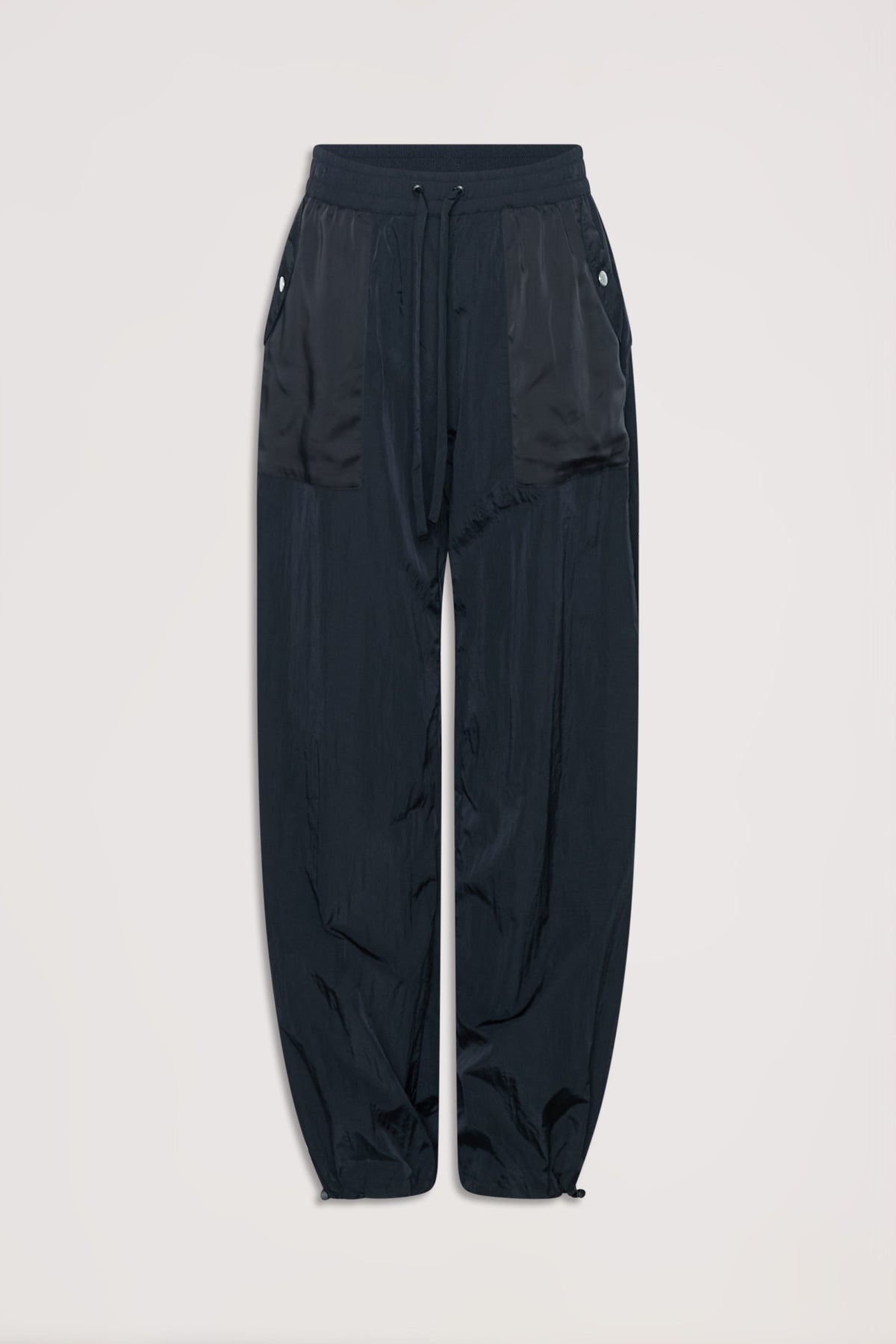 Black relaxed fit parachute-style joggers with drawstring waist and buttoned side pockets.
