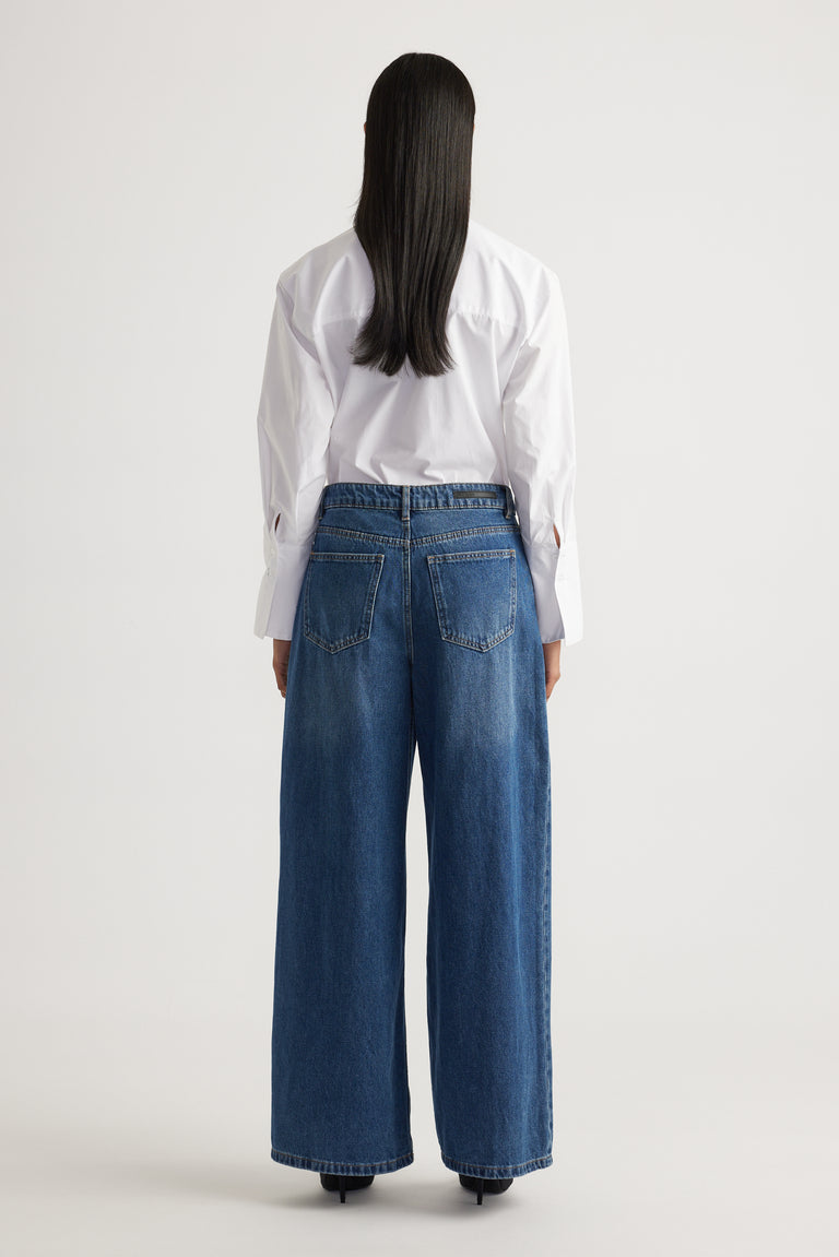 Back view of Elena Wide Leg Jean in classic blue denim with relaxed fit and high waist by Decjuba Australian fashion brand