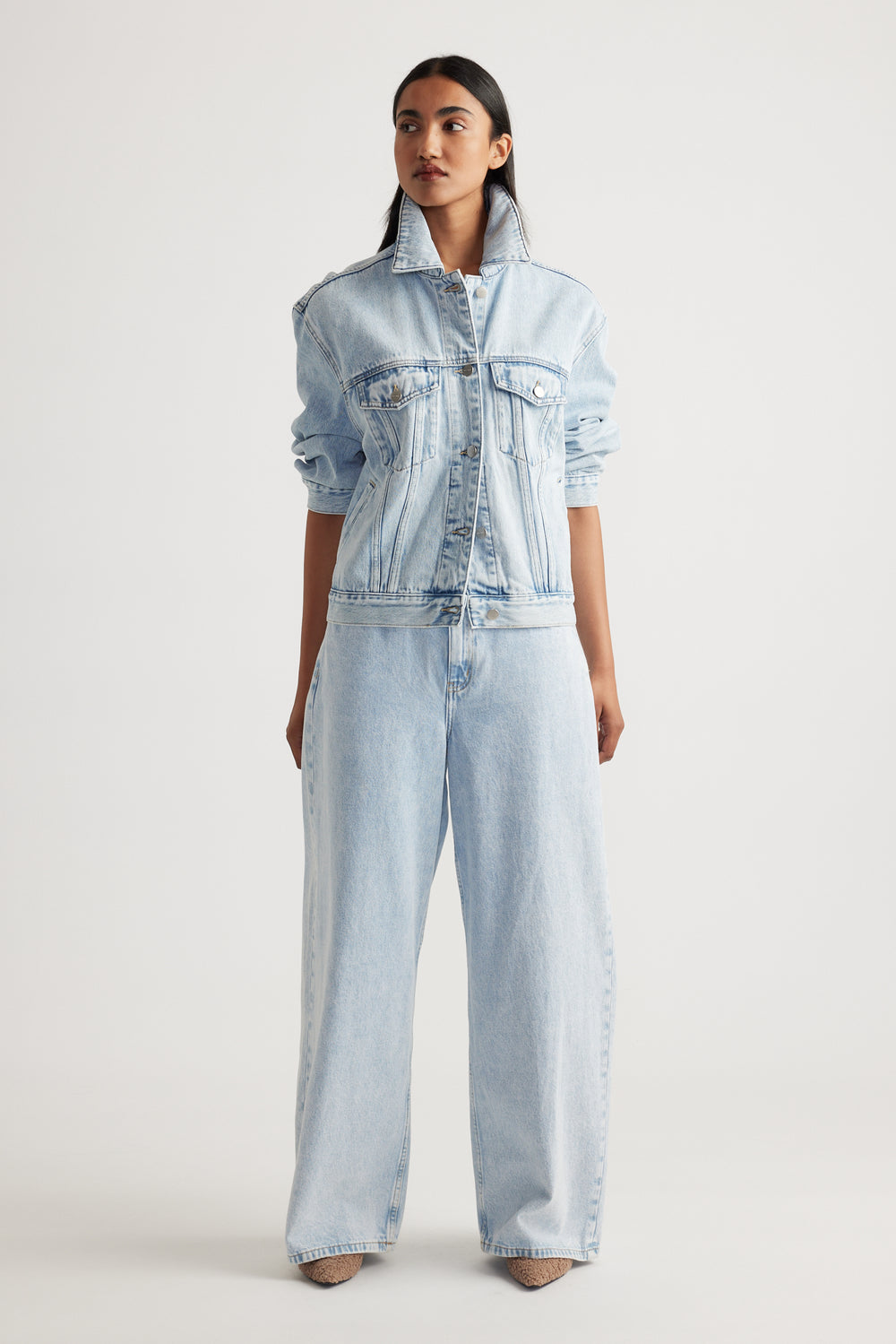 Model wearing Elena Wide Leg Jean in light denim paired with matching denim jacket showcasing effortless Decjuba style