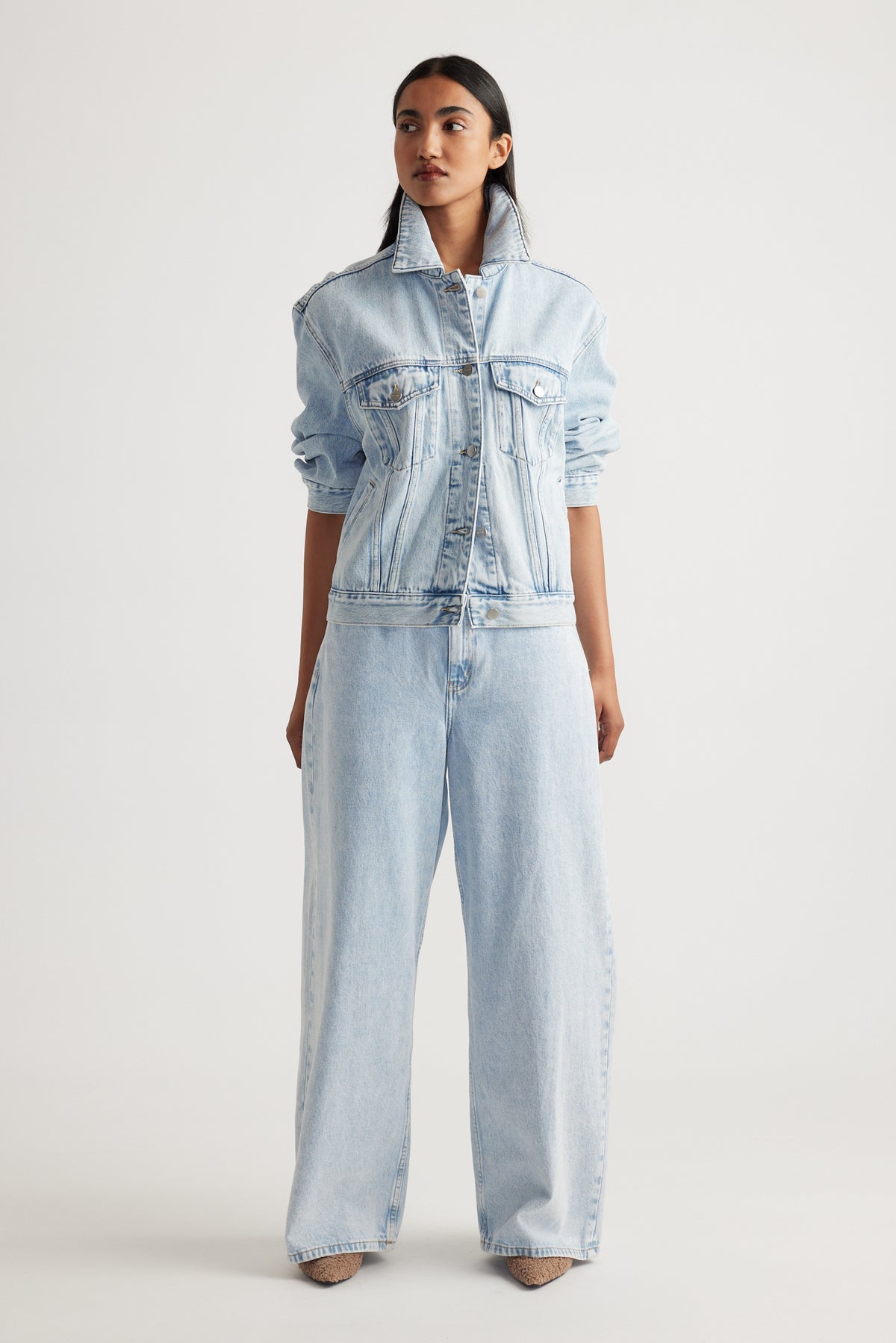 Model wearing Elena Wide Leg Jean in light denim paired with matching denim jacket showcasing effortless Decjuba style