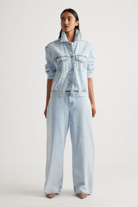 Model wearing Elena Wide Leg Jean in light denim paired with matching denim jacket showcasing effortless Decjuba style